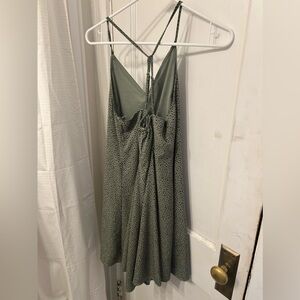 small v-neck green dress with a black pattern